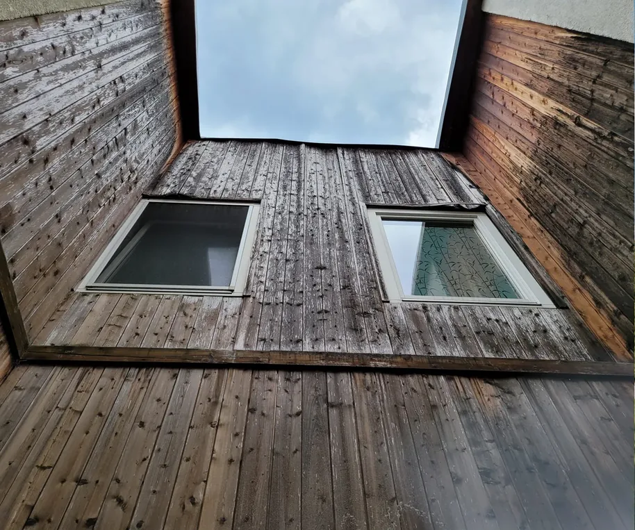 Vorher: verwitterte Holzfassade im Innenhof